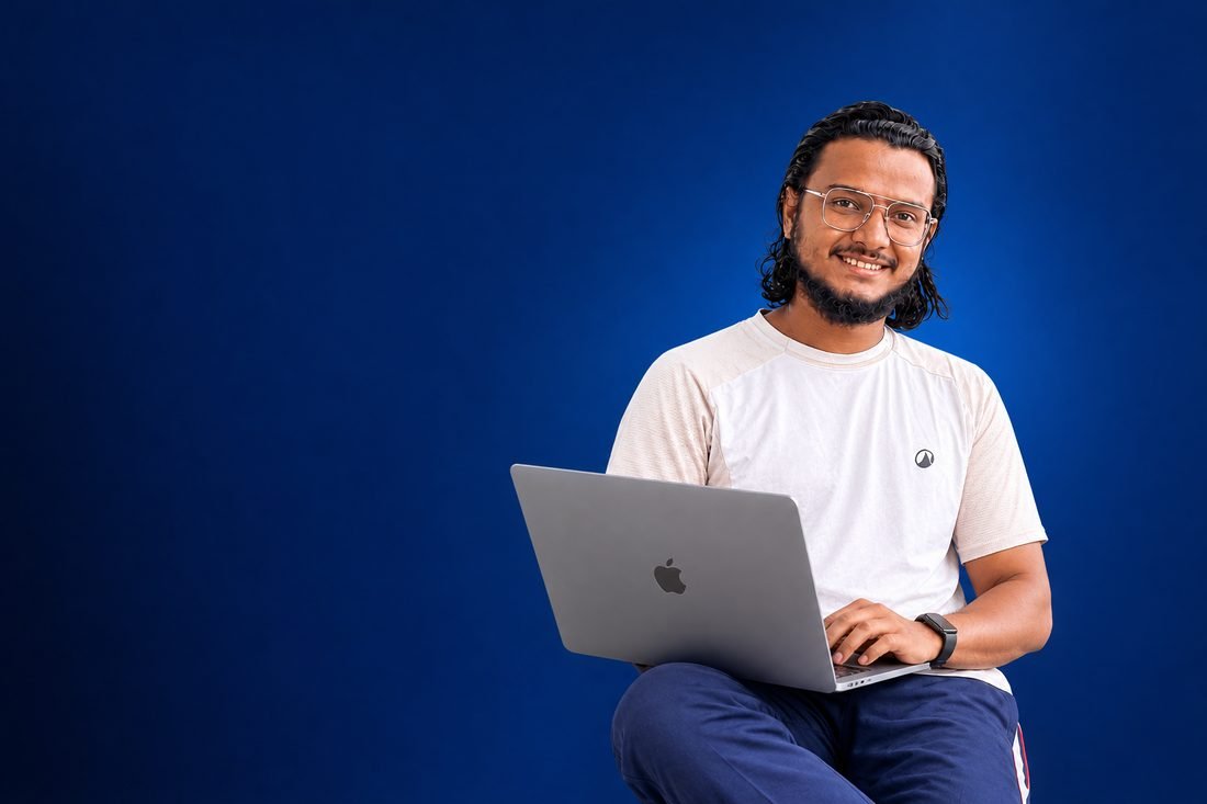 Muhammed Ajmal P smiling with a laptop, digital marketer and SEO specialist